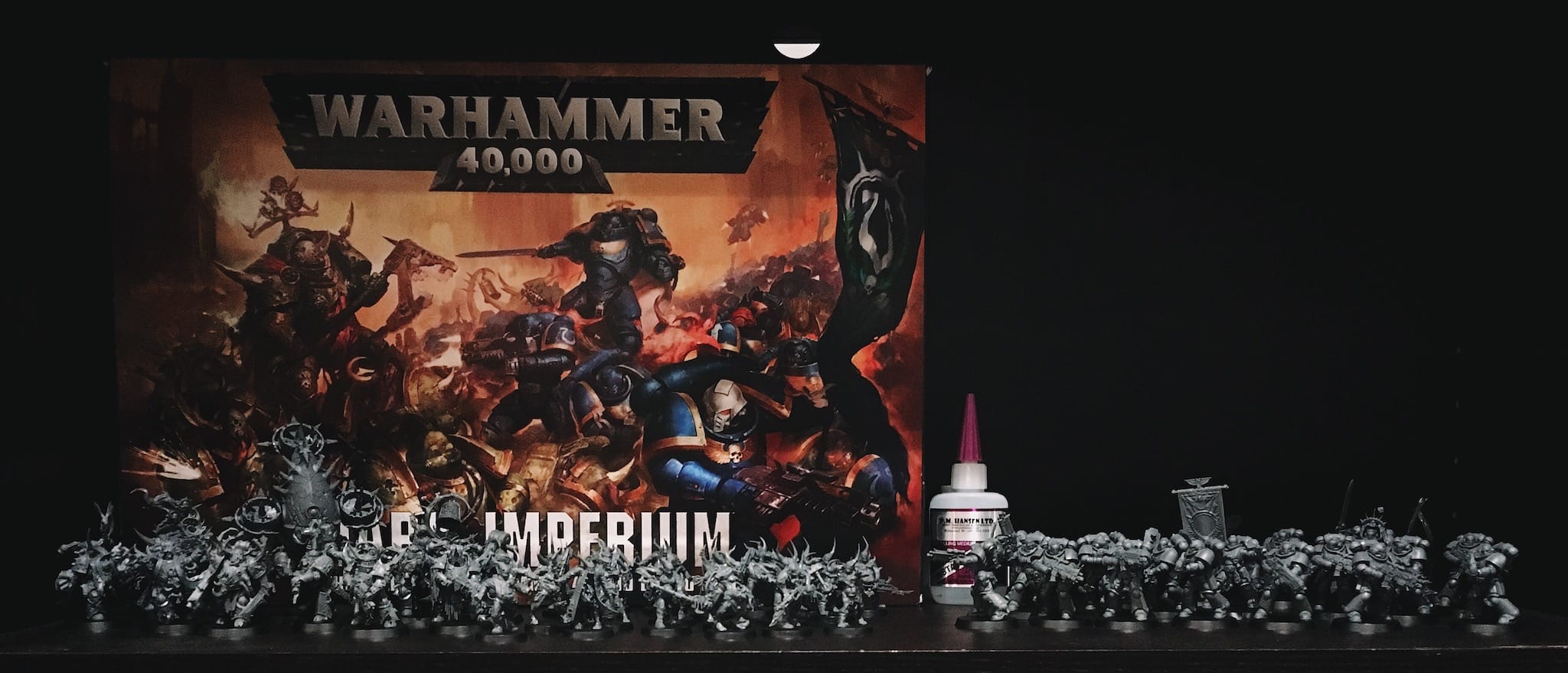 war hammer minis on bookshelf